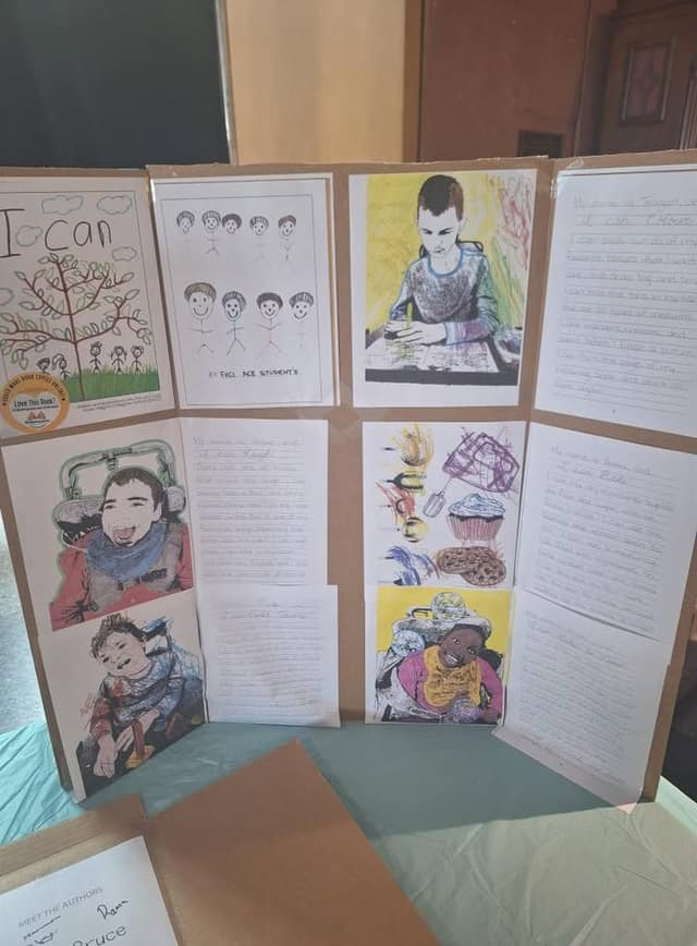 A display board titled "I Can" shows children's drawings, portraits, and handwritten pages; a "Meet the Authors" sheet is at the bottom.