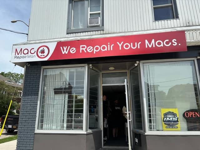 Storefront of Mac Repair Man with a red sign reading "We Repair Your Macs.", an open door, an OPEN sign and number 556.