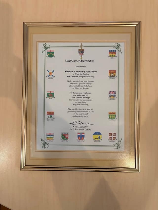 A framed Certificate of Appreciation to the Albanian Community Association, signed by Kelly DeRidder, M.P. Kitchener Centre.
