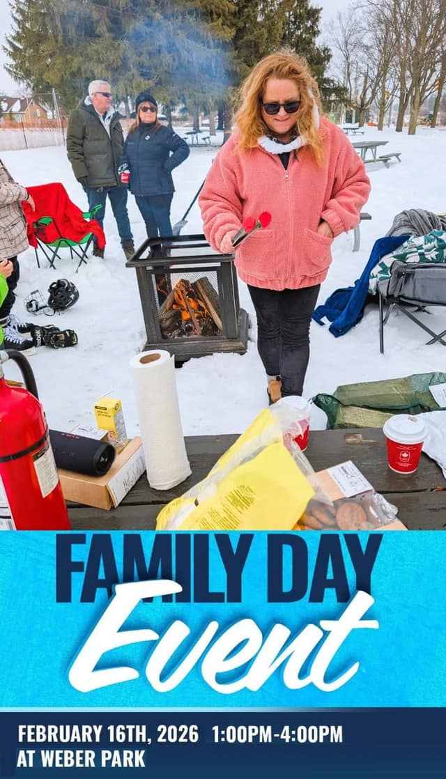 A woman in a pink fleece jacket and sunglasses holds tongs beside a fire pit in a snowy park, with a Family Day Event banner below.