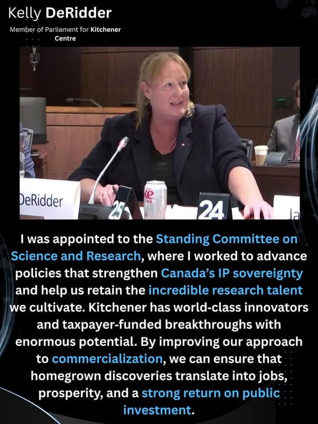 Kelly DeRidder speaks into a microphone at a committee table in a Parliament room, with a DeRidder nameplate and a soda can in front of her.