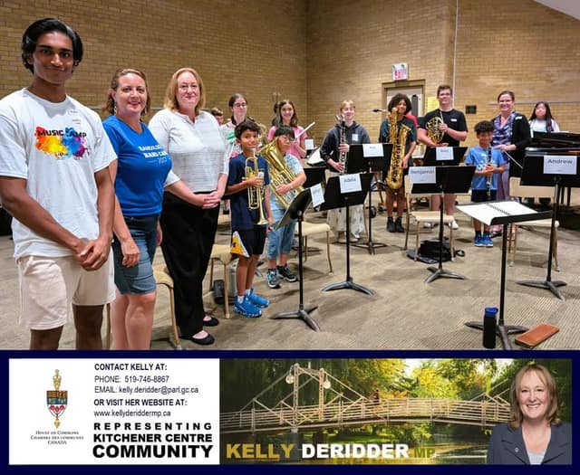 Three adults pose beside young musicians holding trumpets, saxophones and other instruments, standing behind music stands with name cards.