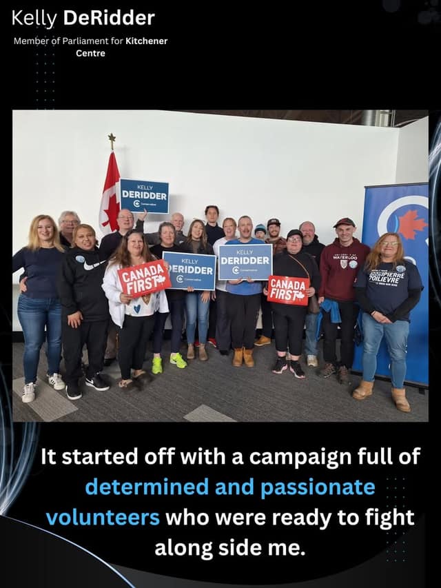 Kelly DeRidder's campaign volunteers pose together indoors holding Kelly DeRidder and Canada First signs beside a Canadian flag and a blue banner.