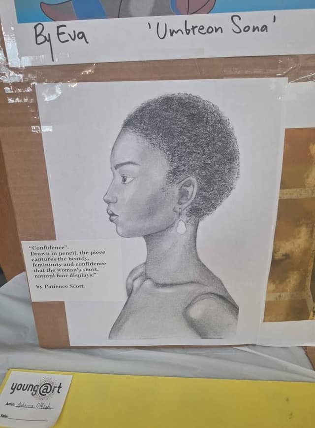 Pencil portrait of a woman in profile with short natural hair, with a caption titled "Confidence" by Patience Scott, on a display board.